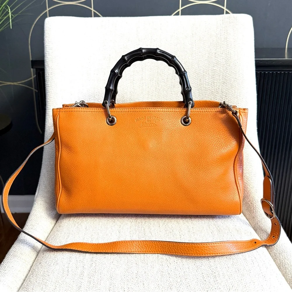 Gucci authentic satchel bag orange leather black bamboo handles with a strap